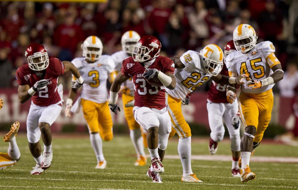 Nov 12, 2011; Fayetteville, AR, USA; Arkansas Razorback running back Dennis Johnson (33) runs the ball for a touchdown as wide receiver Julian Horton (2) follows and Tennessee Volunteers defensive backs Byron Moore (3), Rod Wilks (22), and A.J. Johnson (45) pursue during the first half at Donald W. Reynolds Razorback Stadium. Arkansas defeated Tennessee 49-7. Mandatory Credit: Beth Hall-USA TODAY Sports
