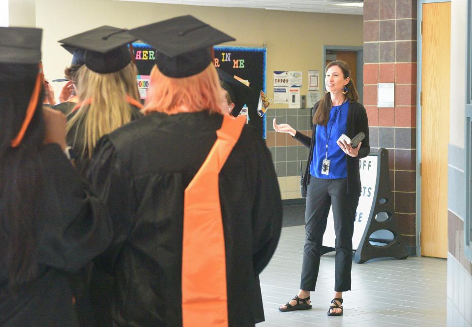 Anne Sullivan Elementary School principal Nikkie Duin greets members of Washington High School's Class of 2023 at the elementary school on Tuesday, May 16, 2023.