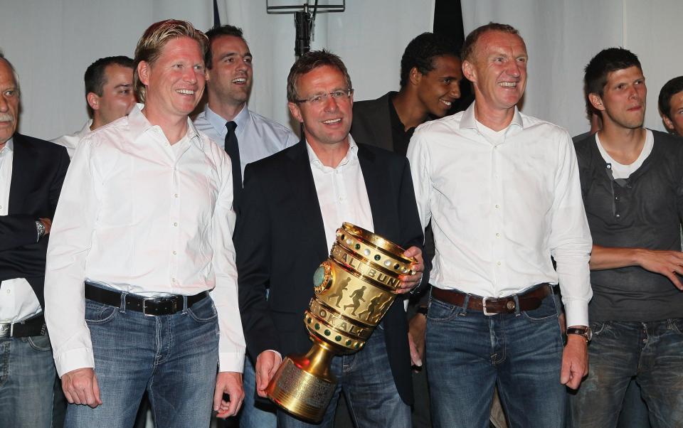 Assistant coach Markus Gisdol, head coach Ralf Rangnick and assistant coach Seppo Eichkorn pose with the trophy during the celebration after the DFB Cup final match between MSV Duisburg and FC Schalke 04 at Olympic Stadium on May 21, 2011 in Berlin, Germany. Schalke won 5-0 against Duisburg. - GETTY IMAGES