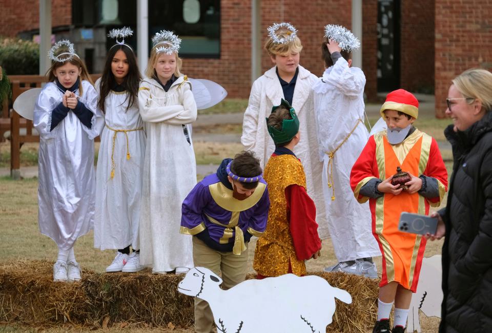 Students dressed as angels and the Three Wise Men take part in a live Nativity scene on Thursday in front of the Lower Division building at Casady School.