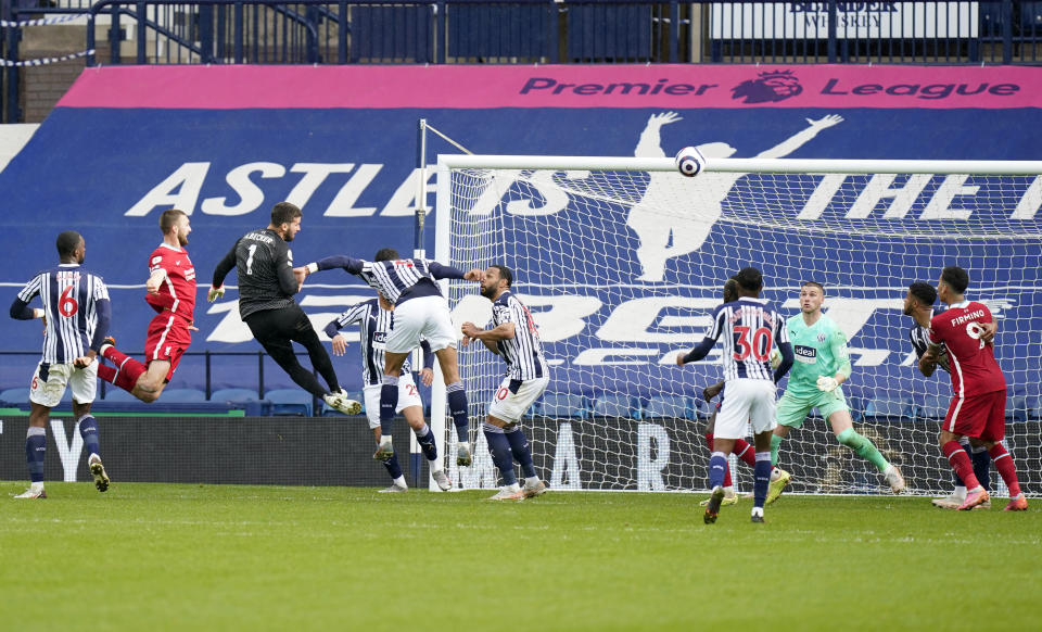 Liverpool's goalkeeper Alisson, third left, scores his side's second goal during the English Premier League soccer match between West Bromwich Albion and Liverpool at the Hawthorns stadium in West Bromwich, England, Sunday, May 16, 2021. (Tim Keeton/Pool via AP)