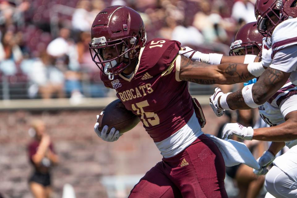 Running back Damarius Good carries the ball downfield while fending off potential tacklers during the Texas State spring game Saturday. The offense and defense kept their schemes basic, and new coach GJ Kinne was pleased with what he saw.