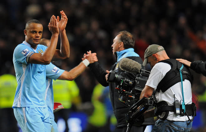 Manchester City's Belgian footballer Vincent Kompany (L) applauds the crowd after beating Manchester United 1-0 during their English Premier League football match at The Etihad stadium in Manchester, north-west England on April 30, 2012. AFP PHOTO/ANDREW YATES RESTRICTED TO EDITORIAL USE. No use with unauthorized audio, video, data, fixture lists, club/league logos or “live” services. Online in-match use limited to 45 images, no video emulation. No use in betting, games or single club/league/player publications.ANDREW YATES/AFP/GettyImages