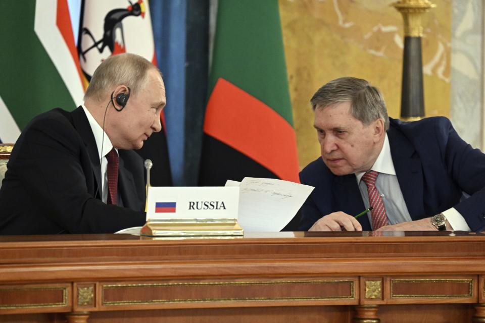 In this photo provided by Photo host Agency RIA Novosti, Russian President Vladimir Putin, left, speaks to his adviser Yuri Ushakov during a meeting with a delegation of African leaders and senior officials in St. Petersburg, Russia, Saturday, June 17, 2023. Seven African leaders — presidents of Comoros, Senegal, South Africa and Zambia, as well as Egypt's prime minister and top envoys from the Republic of Congo and Uganda — traveled to Russia on Saturday a day after visiting Ukraine on a mission to try to help end the hostilities. (Pavel Bednyakov/Photo host Agency RIA Novosti via AP)