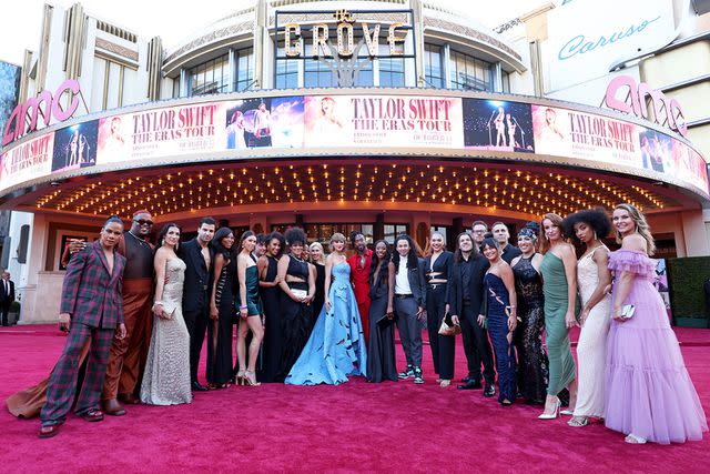 <p>John Shearer/Getty</p> Taylor Swift with her band and singers from the Eras tour at the concert movie's premiere in Los Angeles in October 2023