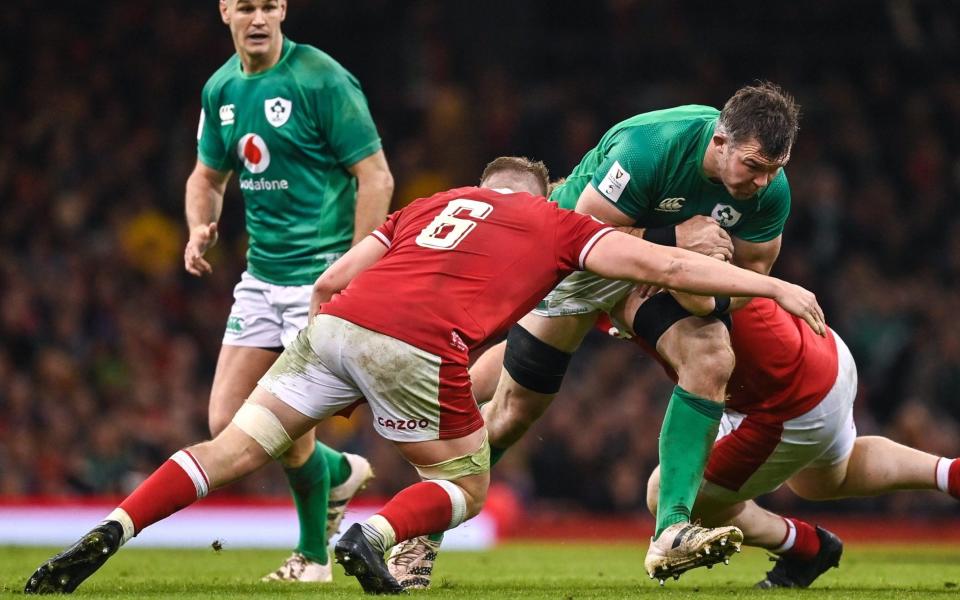 Peter O'Mahony of Ireland is tackled by Jac Morgan and Rhys Carre - Brendan Moran/Getty Images