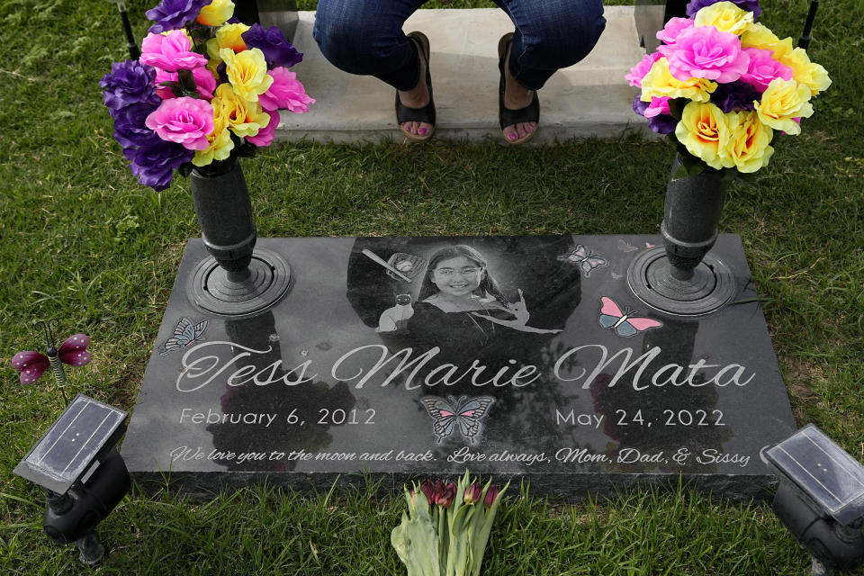 Veronica Mata visits the gravesite of her daugher, Tess, in Uvalde, Texas, Wednesday, May 3, 2023. For Mata, teaching kindergarten in Uvalde after her daughter was among the 19 students who were fatally shot at Robb Elementary School became a year of grieving for her own child while trying to keep 20 others safe. (AP Photo/Eric Gay)