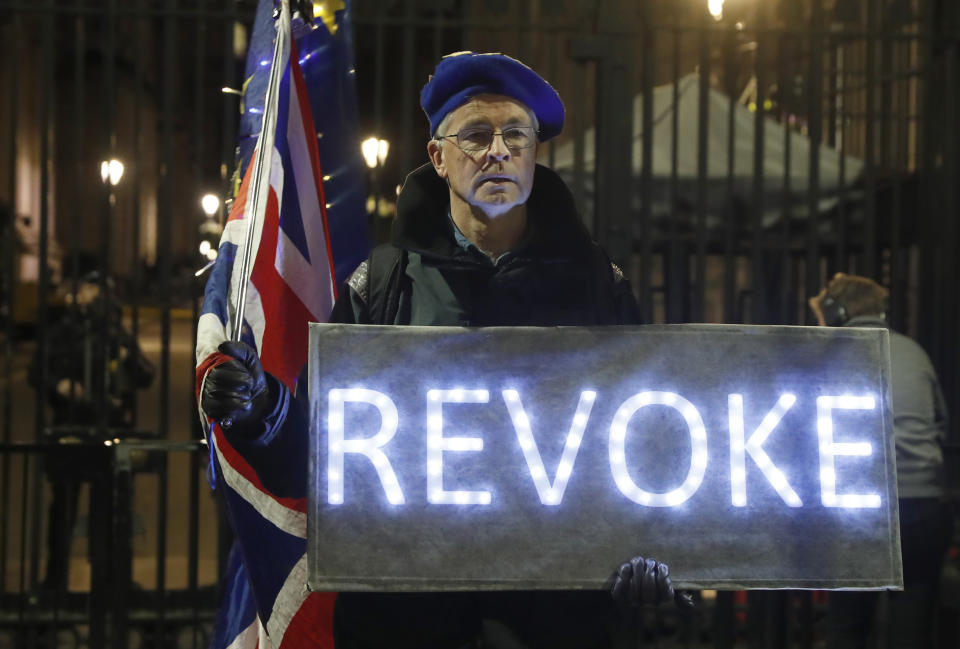 An Anti Leaving the European Union campaigner stands outside the entrance to Downing Street, in London, Wednesday, March 20, 2019. British Prime Minister Theresa May says she has "great personal regret" that the U.K. won't leave European Union with a deal next week and it's time for her country's lawmakers to decide what they want to do about Brexit. (AP Photo/Alastair Grant)