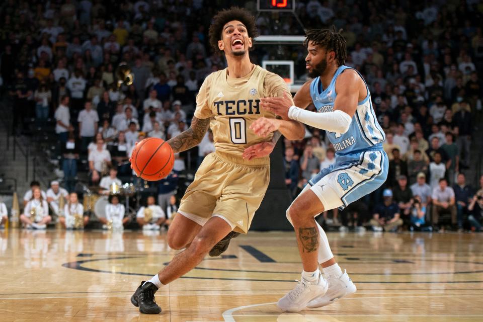 Georgia Tech guard Michael Devoe, left, drives and tries to draw a foul against North Carolina guard RJ Davis on Sunday.