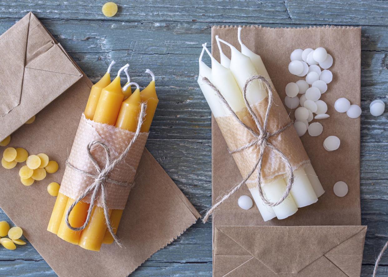 Handmade natural beeswax candles on a wooden background