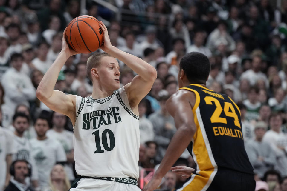 Michigan State forward Joey Hauser (10) looks to pass as Iowa forward Kris Murray (24) defends during the second half of an NCAA college basketball game, Thursday, Jan. 26, 2023, in East Lansing, Mich. (AP Photo/Carlos Osorio)