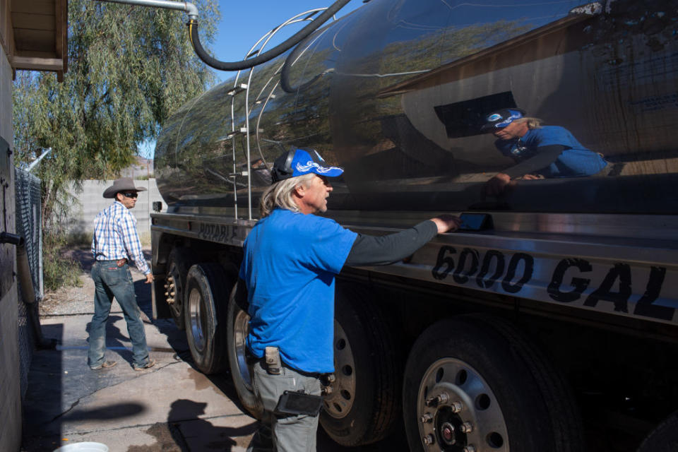 John Hornewer sets alarms on his phone in two minute intervals, after which he puts a quarter in the fill station, as he fills up his 6000 gallon tanker to haul water from Apache Junction to Rio Verde Foothills, Arizona, U.S. on January 7, 2023.<span class="copyright">The Washington Post/Getty Images</span>