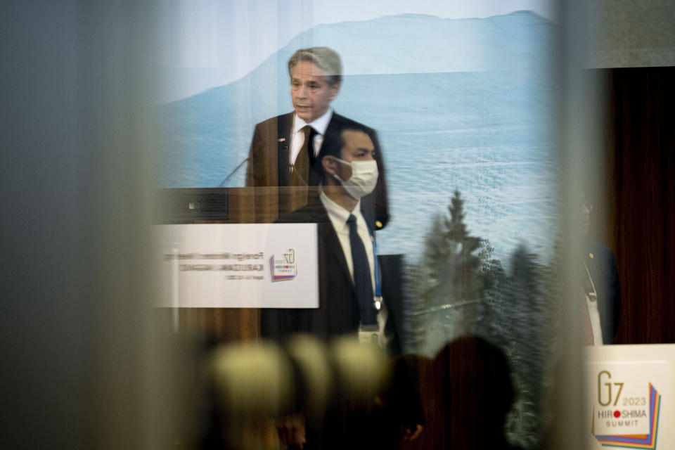 U.S. Secretary of State Antony Blinken, seen in reflection, speaks during a news conference at the conclusion of a G7 Foreign Ministers' Meeting at The Prince Karuizawa hotel in Karuizawa, Japan, Tuesday, April 18, 2023. (AP Photo/Andrew Harnik, Pool)