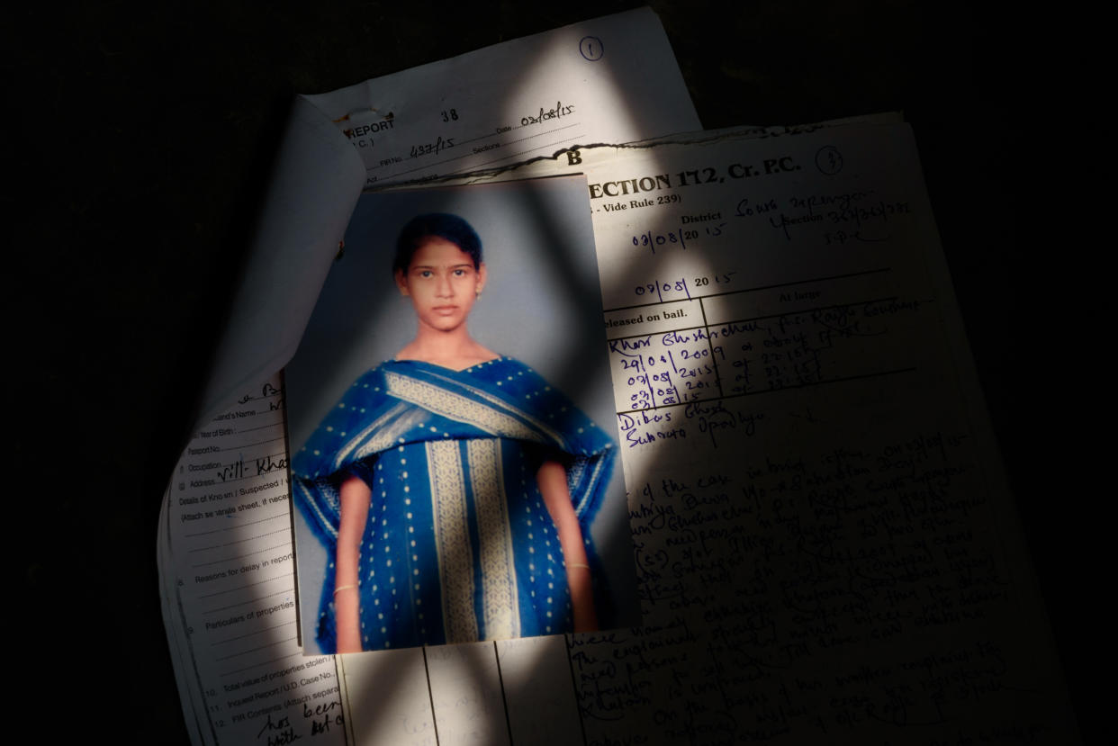 A photograph of a girl of 16, in formal dress, stapled to a police file.