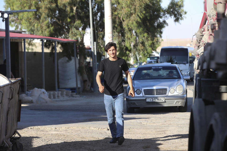 In this photo taken Wednesday, June 7, 2023, Saif Al-Bazaiah, 20, unemployed, walks in Al Qatraneh, Jordan. (AP Photo/Raad Adayleh)
