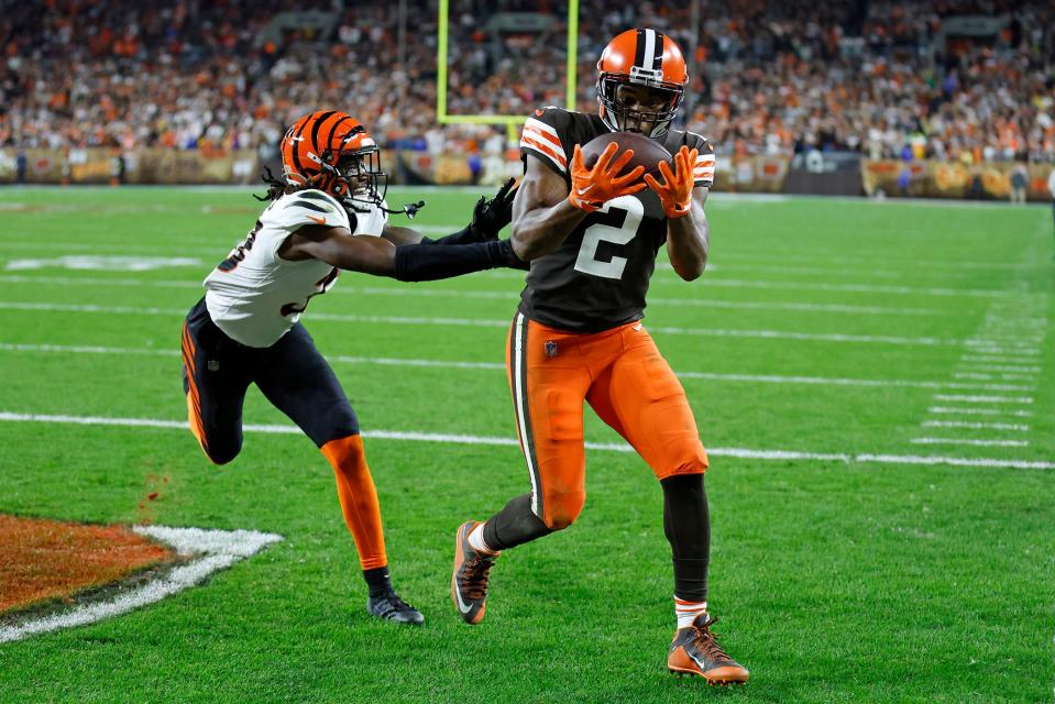 Cleveland Browns wide receiver Amari Cooper (2) catches a pass from quarterback Jacoby Brissett for a touchdown with Cincinnati Bengals cornerback Tre Flowers (33) defending during the second half of an NFL football game in Cleveland, Monday, Oct. 31, 2022. (AP Photo/Ron Schwane)