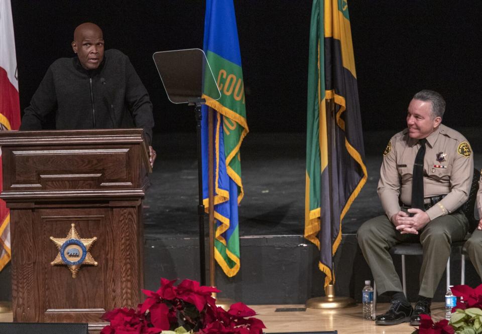 Big Boy, left, emcees the swearing-in ceremony for Los Angeles County Sheriff Alex Villanueva, right, on Dec. 3, 2018.