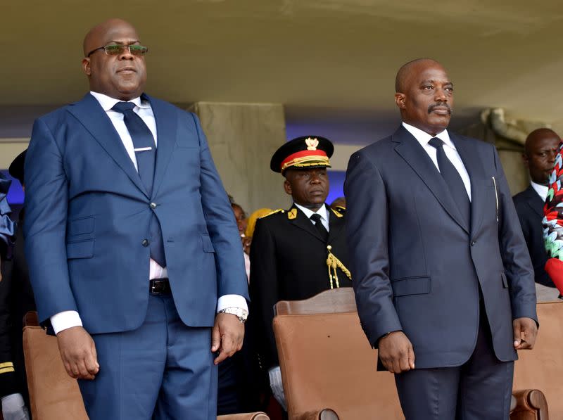 FILE PHOTO: Democratic Republic of Congo's outgoing President Joseph Kabila and his successor Felix Tshisekedi stand during an inauguration ceremony in Kinshasa