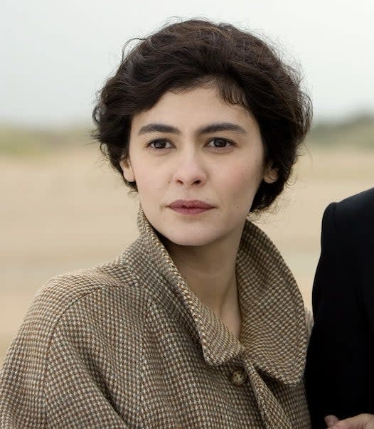 Close-up of Audrey as Coco in a checkered coat