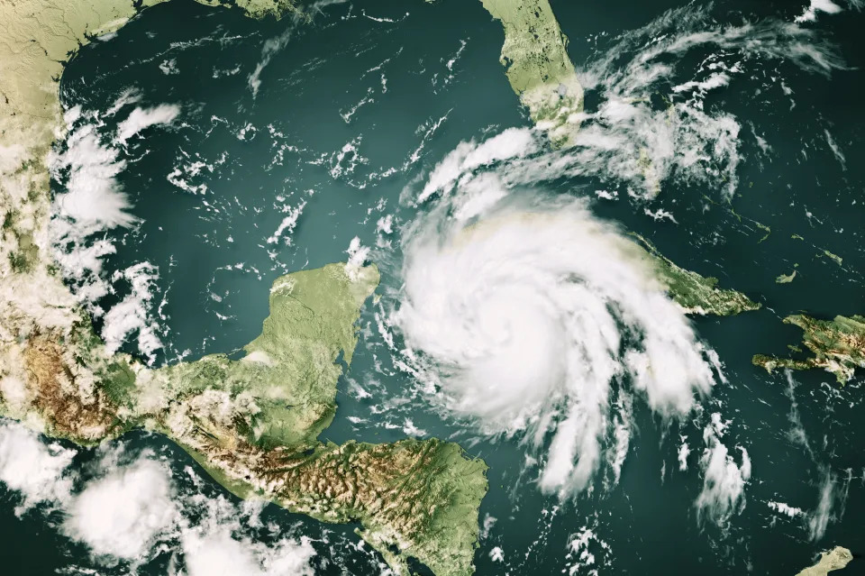 3D Render of a Topographic Map of the Caribbean Sea with the clouds from September 26, 2022. 
Major Hurricane Ian approaching Western Cuba.
All source data is in the public domain.
Cloud texture: Global Imagery Browse Services (GIBS) courtesy of NASA, GOES data courtesy of NOAA.
https://www.earthdata.nasa.gov/eosdis/science-system-description/eosdis-components/gibs
Color texture: Made with Natural Earth.
http://www.naturalearthdata.com/downloads/10m-raster-data/10m-cross-blend-hypso/
Relief texture: GMTED 2010 data courtesy of USGS. URL of source image:
https://topotools.cr.usgs.gov/gmted_viewer/viewer.htm
Water texture: SRTM Water Body SWDB: https://dds.cr.usgs.gov/srtm/version2_1/SWBD/