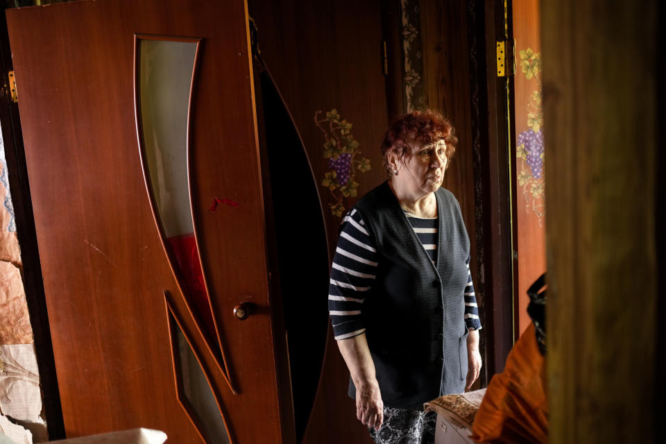 Ludmila Telehyna, 73, stands in her home apartment in a building damaged in an overnight missile strike in Sloviansk, Ukraine, Tuesday, May 31, 2022. (AP Photo/Francisco Seco)
