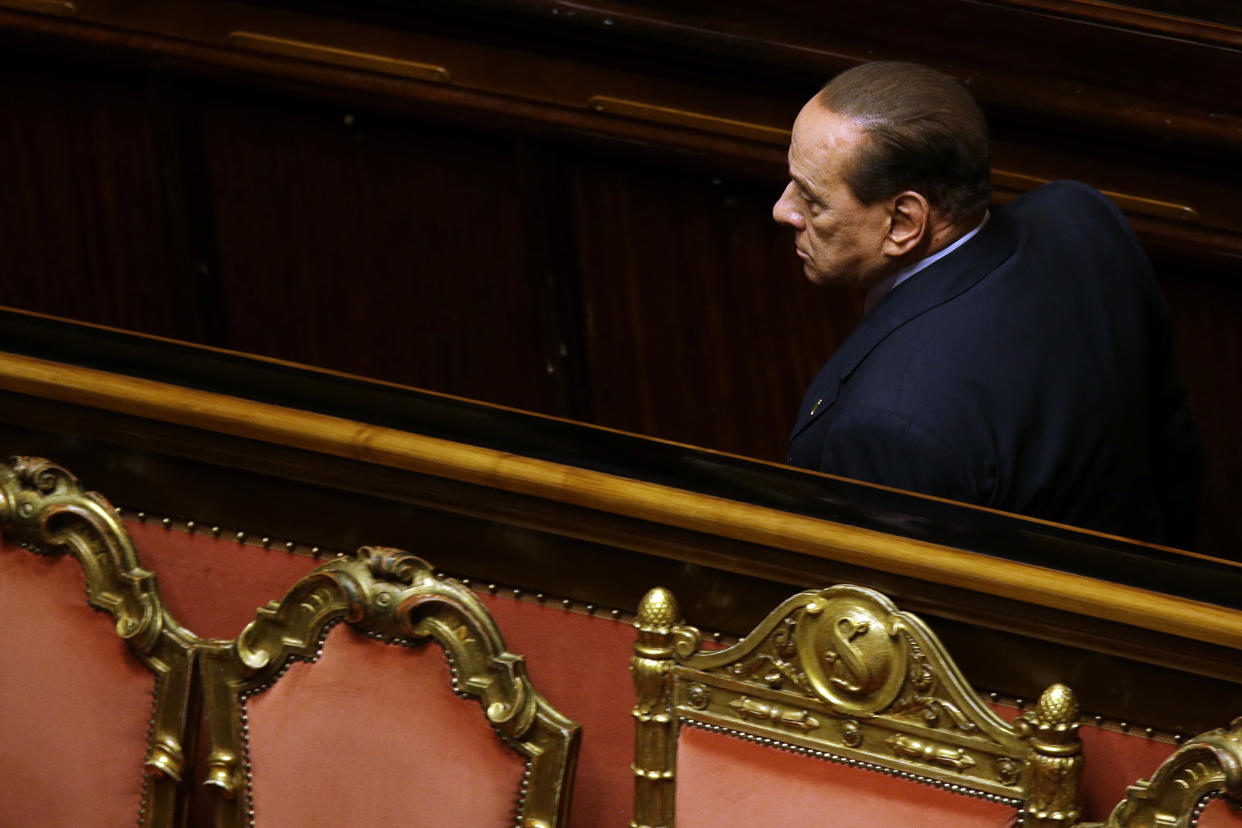 FILE - Forza Italia leader Silvio Berlusconi passes past the Government and Presidency seat during a confidence vote at the Senate, in Rome, Wednesday, Oct. 2, 2013. Just in time to celebrate his 86th birthday, Italy’s former premier Silvio Berlusconi is making his return to Italy's parliament, winning a seat in the Senate nearly a decade after being banned from public office over a tax fraud conviction. (AP Photo/Gregorio Borgia, File)