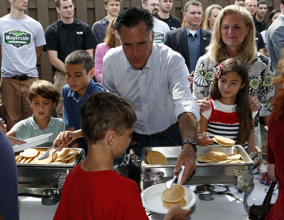 Mitt Romney serve pancakes while attending a pancake breakfast at Mapleside Farms in Brunswick