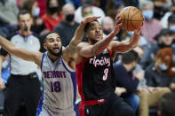 Portland Trail Blazers guard CJ McCollum, right, is fouled by Detroit Pistons guard Cory Joseph during the second half of an NBA basketball game in Portland, Ore., Tuesday, Nov. 30, 2021. (AP Photo/Craig Mitchelldyer)