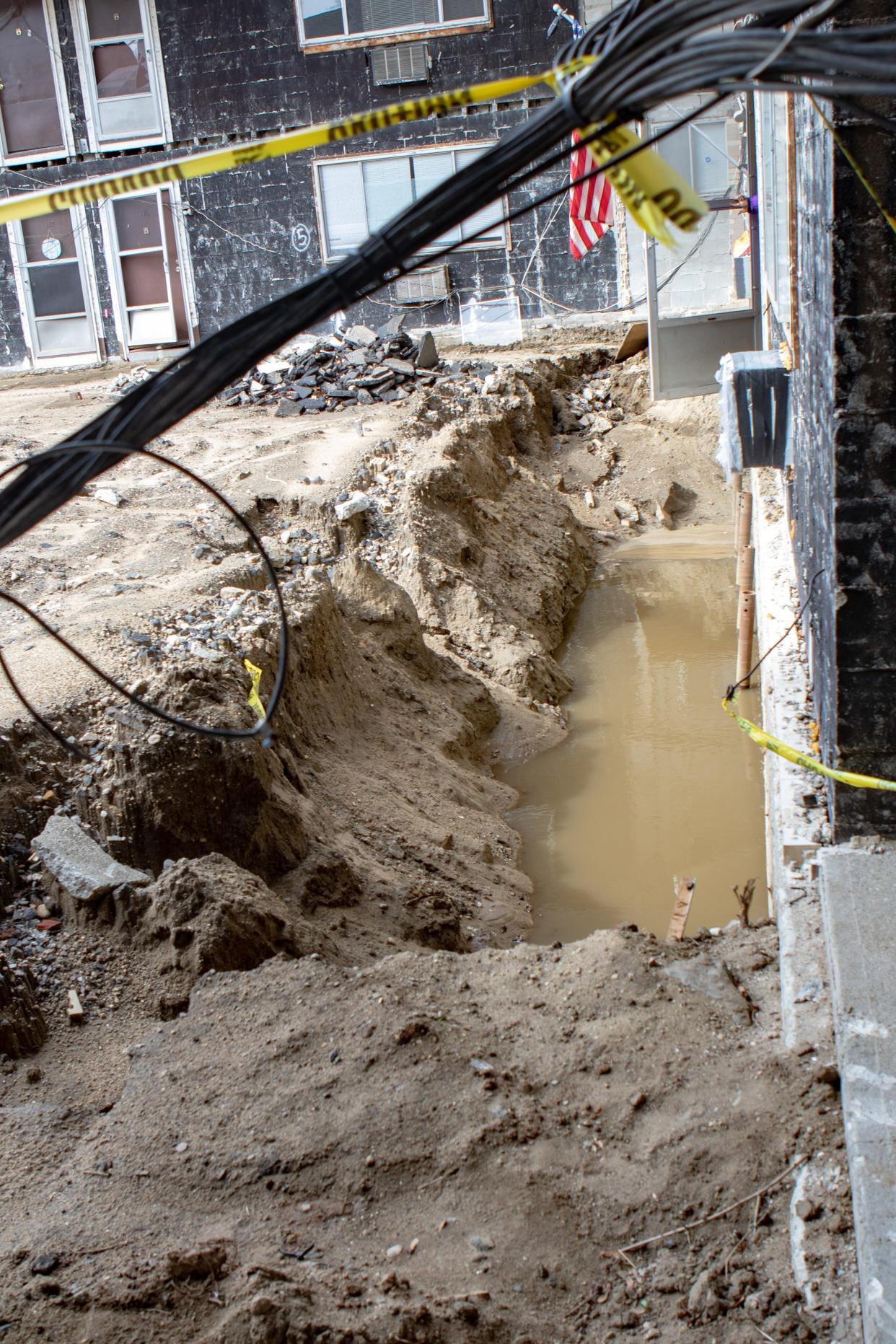 The front door of Eugene Velasquez's apartment also opens to a trench along the side at 1890 Broad St. in Cranston.