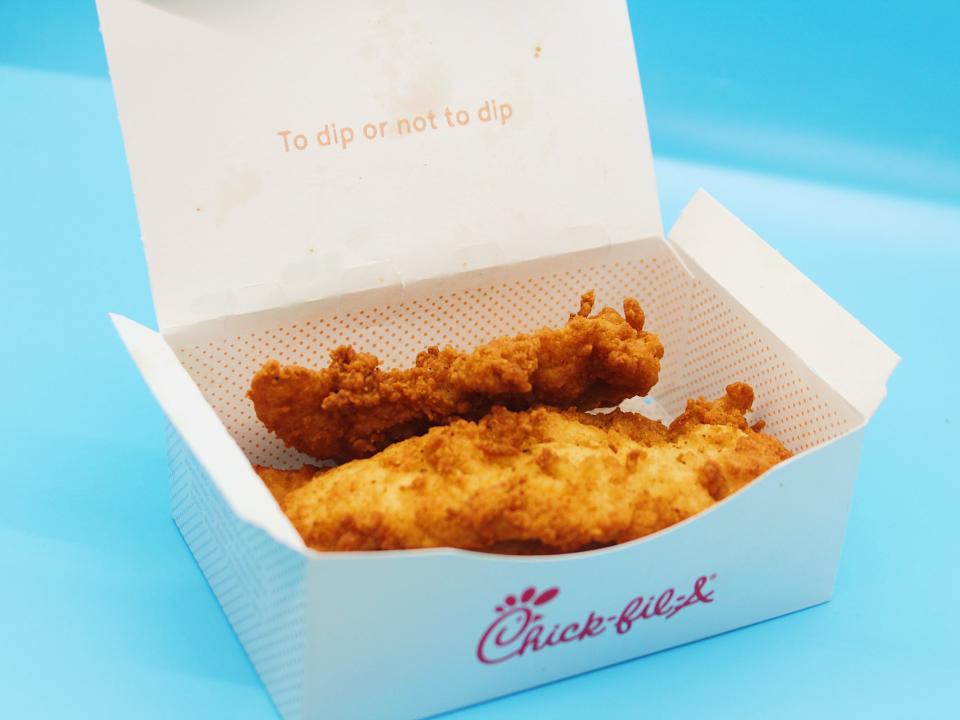 chick fil a chicken tenders in box on blue background