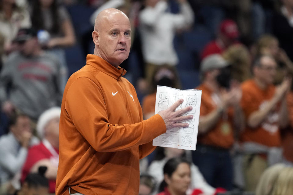 Texas head coach Jerritt Elliott calls a play against Wisconsin during a semifinal match in the NCAA Division I women's college volleyball tournament Thursday, Dec. 14, 2023, in Tampa, Fla. (AP Photo/Chris O'Meara)