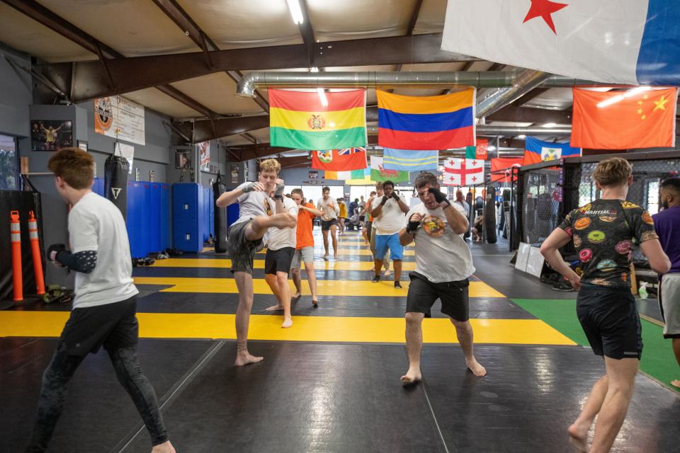Students warm up and practice their skills during a class at Train. Fight. Win. on Tuesday, April 30, 2024.