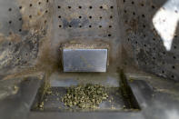 Alfalfa pellets sit in a GreenFeed machine waiting to be eaten by cattle at Colorado State University's research pens in Fort Collins, Colo., Thursday, March 9, 2023. The methane, carbon and other gases that cattle breathe out are measured in the machines while the pellets entice them to stay and keep eating. (AP Photo/David Goldman)