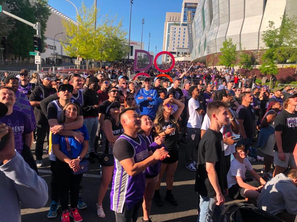 Sacramento Kings fans fill the Section 916 outdoor watch party on L Street in downtown Sacramento, where they can watch the game on large screens mounted on a parking garage, at the start of the team’s first game against the Golden State Warriors in the NBA playoff series on Saturday.