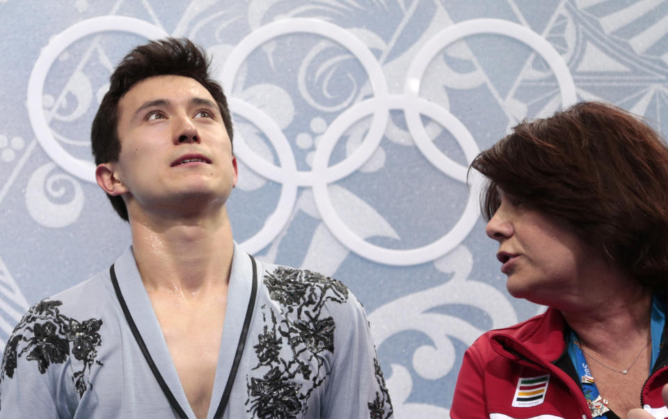 Patrick Chan of Canada and his coach Kathy Johnson, right, sit in the results area after the men's free skate figure skating final at the Iceberg Skating Palace at the 2014 Winter Olympics, Friday, Feb. 14, 2014, in Sochi, Russia. (AP Photo/Ivan Sekretarev)