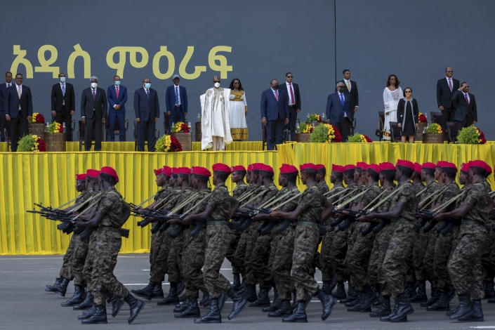 Ethiopia's Prime Minister Abiy Ahmed, far right, salutes during a military parade accompanied by First Lady Zinash Tayachew, second right, and other dignitaries at Abiy's inauguration ceremony after he was sworn in for a second five-year term, in the capital Addis Ababa, Ethiopia Monday, Oct. 4, 2021. Abiy was sworn in Monday for a second five-year term running a country in the grip of a nearly year-long war, as a handful of visiting African leaders urged him to hold the nation together. (AP Photo/Mulugeta Ayene)