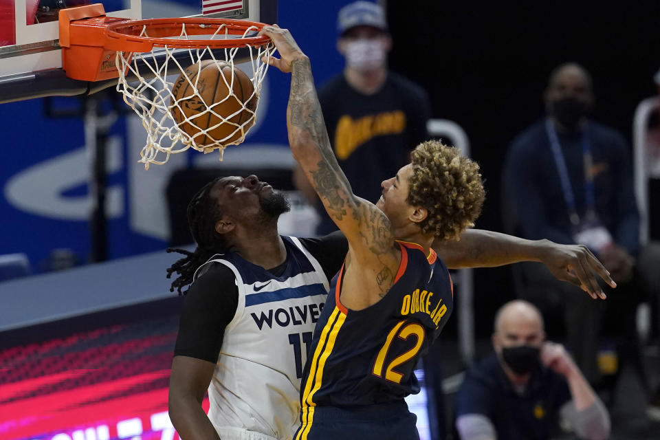 Golden State Warriors guard Kelly Oubre Jr. (12) dunks against Minnesota Timberwolves center Naz Reid during the first half of an NBA basketball game in San Francisco, Wednesday, Jan. 27, 2021. (AP Photo/Jeff Chiu)