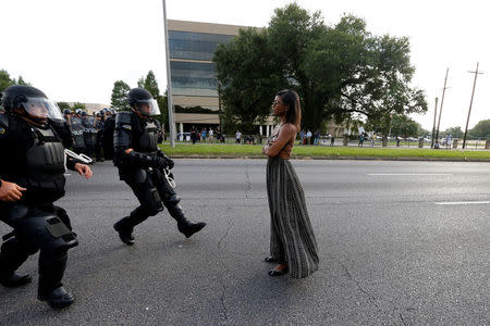 Protestor Ieshia Evans is approached by law enforcement near the headquarters of the Baton Rouge Police Department in Baton Rouge, Louisiana, U.S. July 9, 2016. REUTERS/Jonathan Bachman