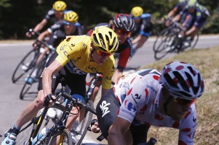 Team Sky rider Chris Froome of Britain (C), race leader's yellow jersey, cycles during the 188-km (116.8 miles) 11th stage of the 102nd Tour de France cycling race from Pau to Cauterets in the French Pyrenees mountains, France, July 15, 2015. REUTERS/Eric Gaillard