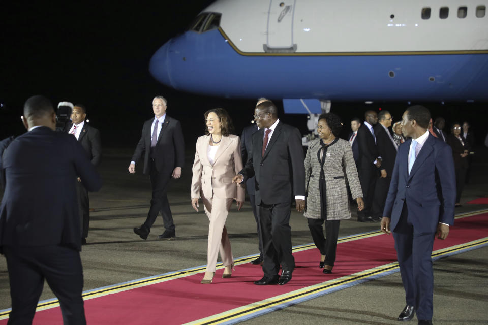 U.S. Vice President Kamala Harris, center left, and her husband Douglas Emhoff, party seen center rigth, are welcomed by Tanzania's Vice President Philip Mpango, third right, as they arrive at Julius Nyerere International Airport in Dar es Salaam Wednesday, March 29, 2023. (Ericky Boniphace/Pool Photo via AP)