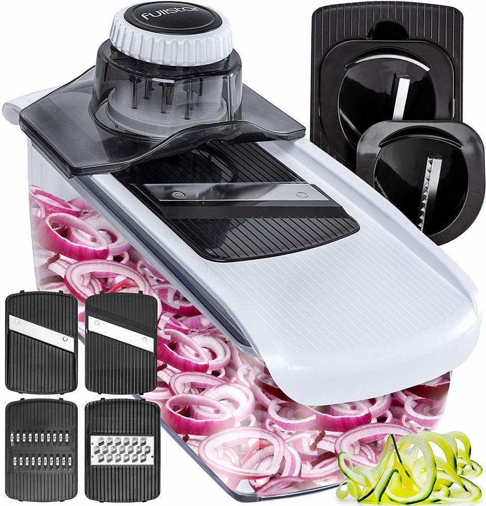 a fullstar mandoline with five attachments and onions cut up in the attached box on a white background