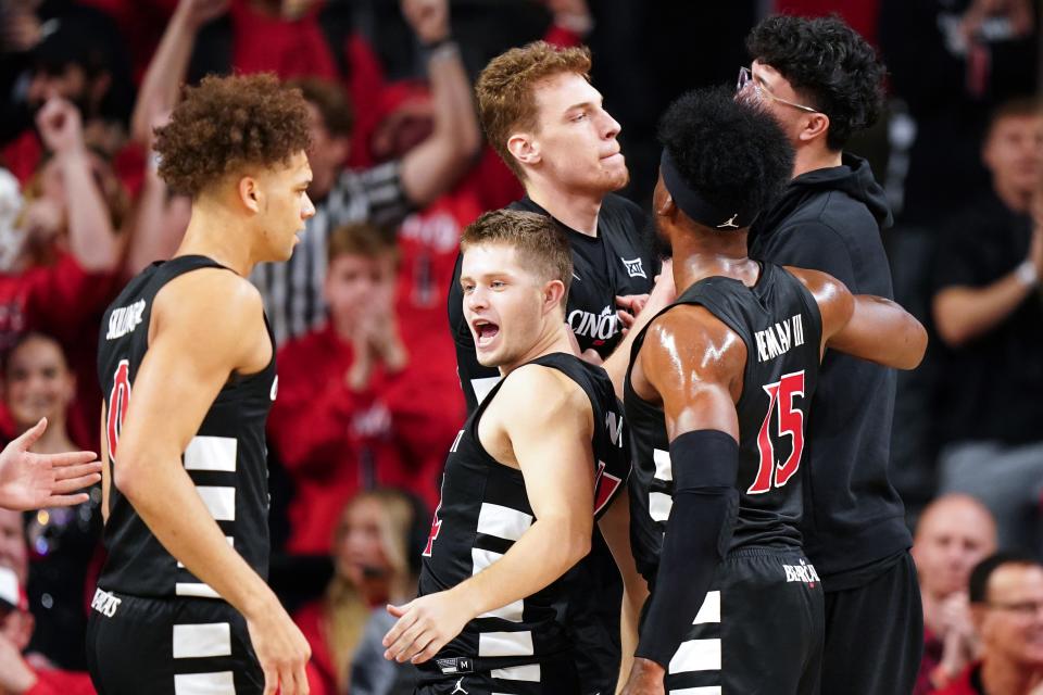 Cincinnati Bearcats forward Viktor Lakhin (30), center, is congratulated on after a made 3-point basket in the first half during an NCAA college basketball game between Georgia Tech Yellow Jackets and the Cincinnati Bearcats, Wednesday, Nov. 22, 2023, at Fifth Third Arena in Cincinnati.