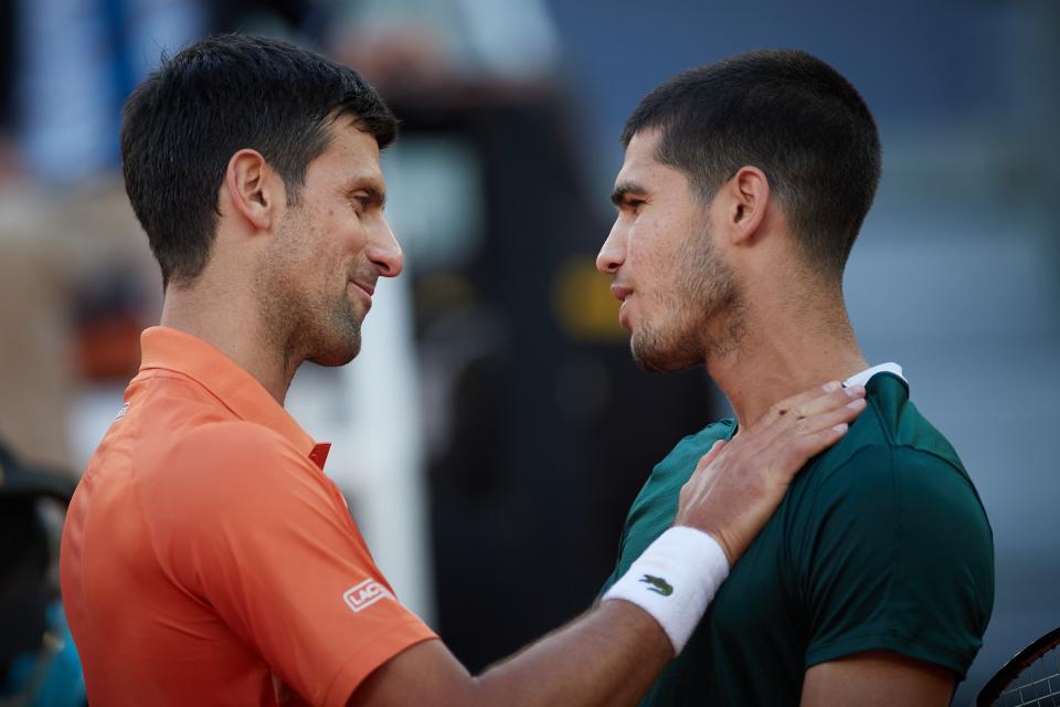 Novak Djokovic (left) of Serbia greets Carlos Alcaraz of Spain after their meeting in the men's singles semifinal at the 2022 Madrid Open. (Photo by Meng Dingbo/Xinhua via Getty Images)