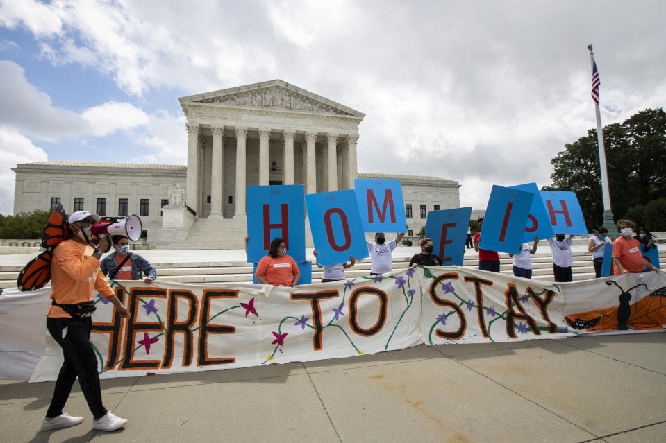 Deferred Action for Childhood Arrivals (DACA) recipient Roberto Martinez, left, celebrates with other DACA recipients in front of the Supreme Court on Thursday, June 18, 2020, in Washington. The Supreme Court on Thursday rejected President Donald Trump’s effort to end legal protections for 650,000 young immigrants, a stunning rebuke to the president in the midst of his reelection campaign. (AP Photo/Manuel Balce Ceneta)