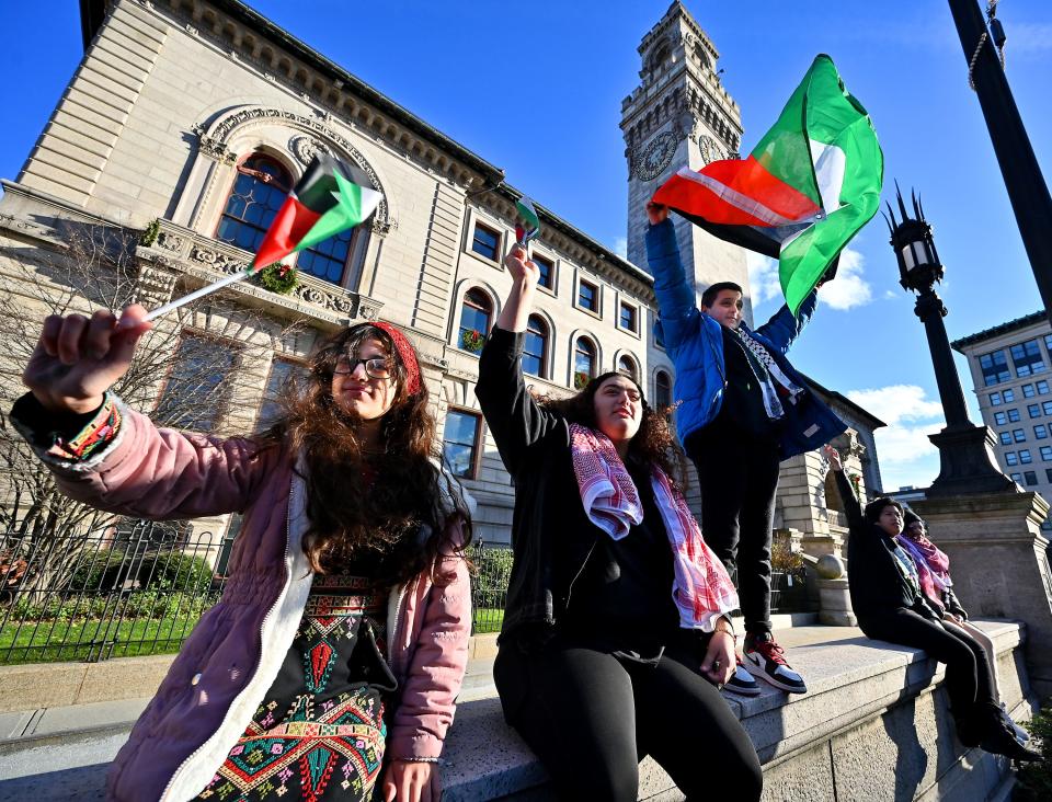 Siblings of Palestinian descent Jawaher, 11, Sabah, 20, and Yousef Hammad, 11, of Worcester wave flags during a Free Palestine rally at City Hall on Friday.