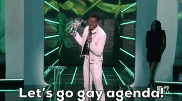 Lil Nas X saying "Let's go, gay agenda!" at a microphone