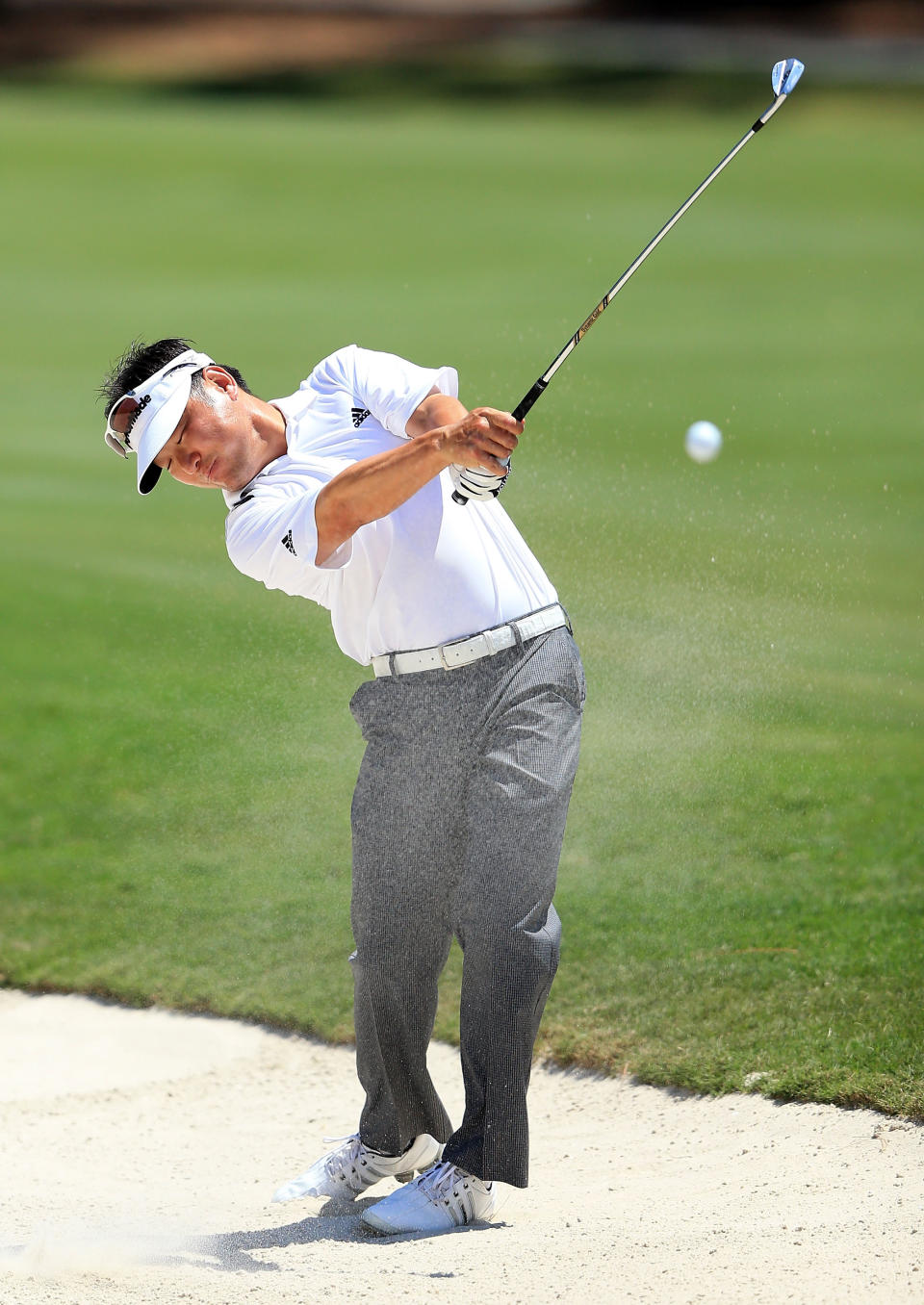 PONTE VEDRA BEACH, FL - MAY 10: Charlie Wi of the USA plays his second shot at the par 4, 15th hole during the first round of THE PLAYERS Championship held at THE PLAYERS Stadium course at TPC Sawgrass on May 10, 2012 in Ponte Vedra Beach, Florida. (Photo by David Cannon/Getty Images)