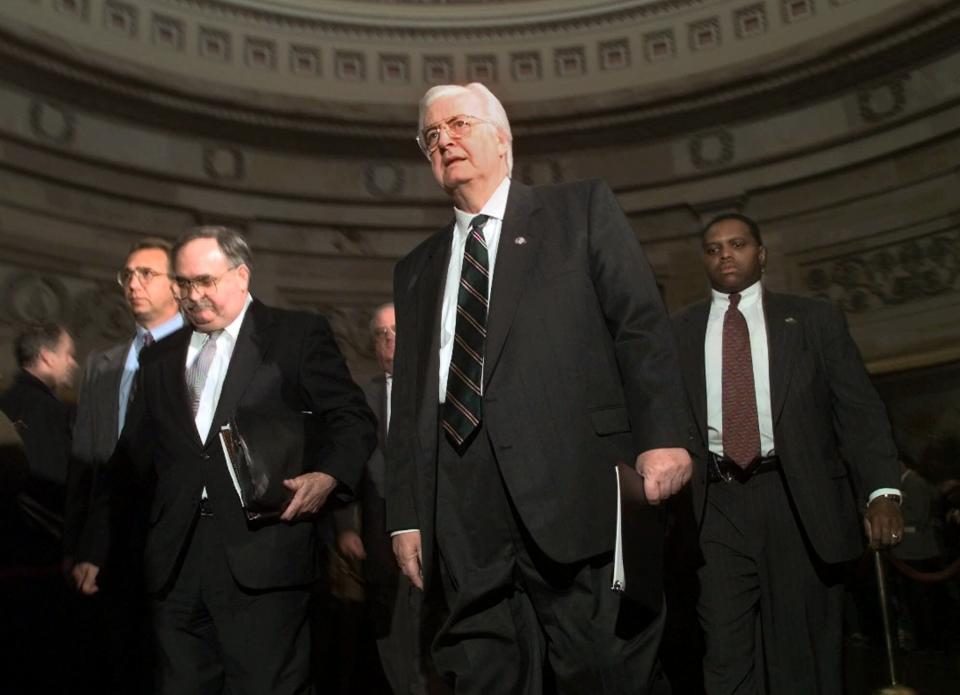 House Judiciary Committee Chairman Rep. Henry Hyde, R-Ill., center, accompanied by committee counsel Thomas Mooney, left, and other Republican committee members, walks to the Senate Chamber on Capitol Hill Thursday Jan. 7, 1999 to deliver his committee's articles of impeachment against President Clinton. (Photo: Khue Bui)/AP