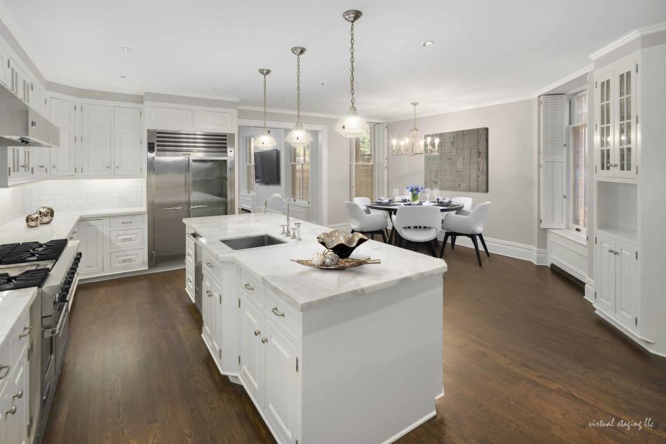 11) The kitchen features a large center island and breakfast nook.