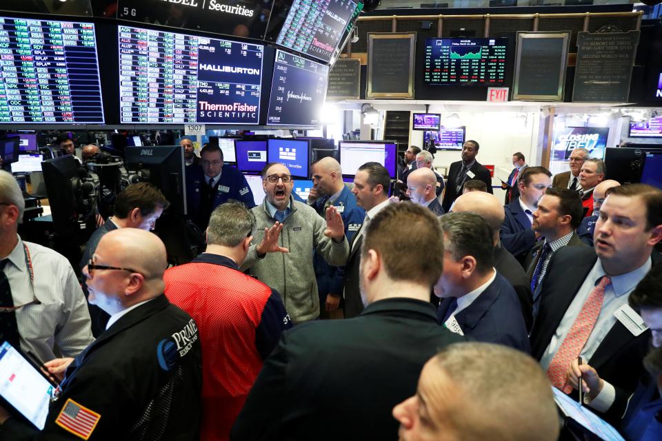 FILE PHOTO: Traders work on the floor of the New York Stock Exchange shortly after the closing bell in New York, U.S., March 13, 2020. REUTERS/Lucas Jackson